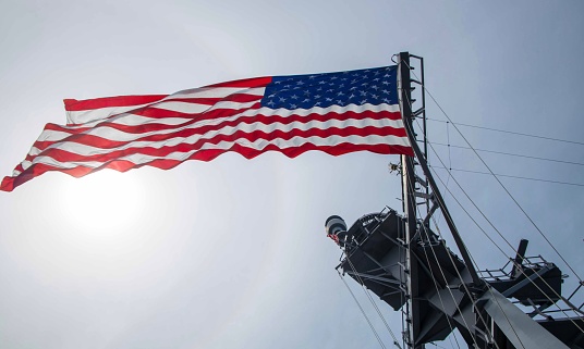 Pearl Harbor, USA - April 1st, 2022: US Navy Jack flag flying over the bow of USS Missouri. National historic sites at Pearl Harbor tell the story of the battle that plunged US into World War II.
