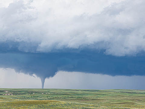 A cloud funnel over a green landscape in the north of Casper, Wyoming