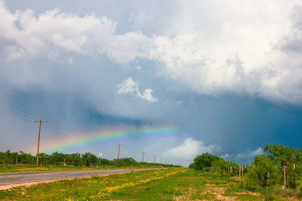 A colorful rainbow arches over the southwest Texas prairie