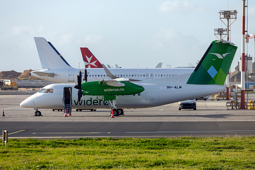 Kolkata, West Bengal, India - May 14 2019 : Passengers are boarding flight at Kolkata International airport, while ground crews checking their boarding passes and helping them to borad the plane.