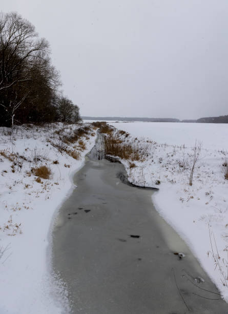 istock spots from falling snowflakes are visible on the river and sky 2069126664
