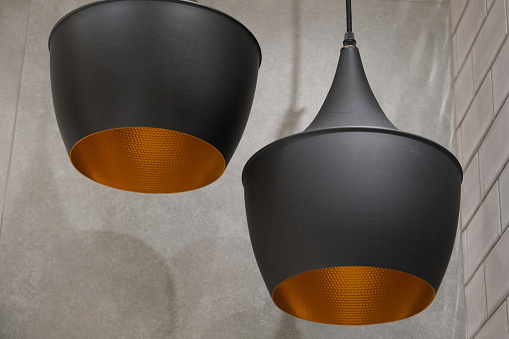 two black lamps on a background of gray walls