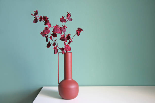 istock Blooming branch in a modern ceramic vase on a white table. 2069151207