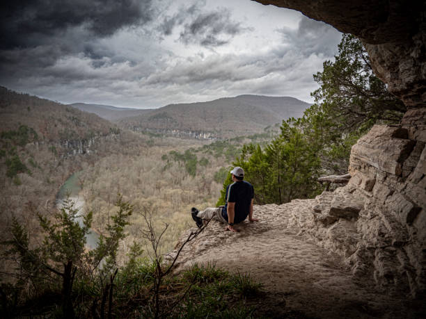 istock Man resting on a cliff overlook after a hike 2069183948