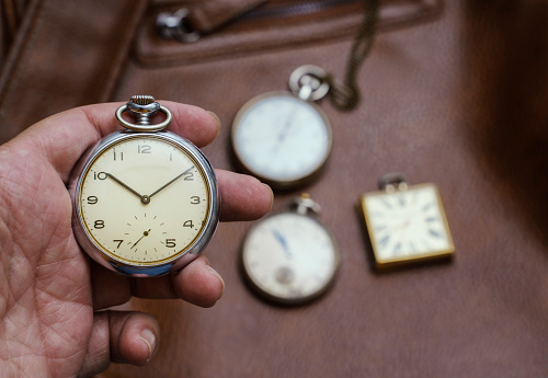 Vintage pocket watch and hour glass or sand timer, symbols of time with copy space