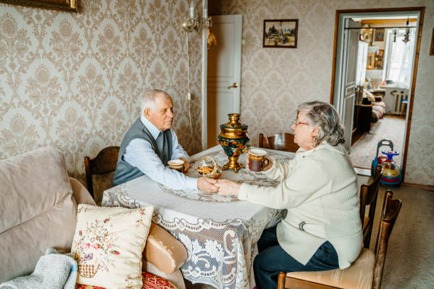 istock Elderly senior romantic love couple drinking tea with cookies from samovar. Old retired man woman together. Aged husband wife in cozy home. Elder people. Happy family longevity. Tender relationships 2069238794