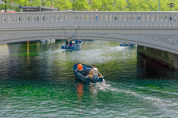 Summer vacation people sailing a boat on a river canal in the city of Copenhagen, Denmark - August 20, 2023