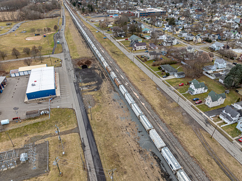 Sayre, PA, USA - 03-03-2024 - Cloudy winter aerial image of a bulk materials railroad car near downtown area in the City of Sayre, PA.