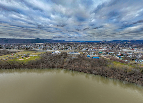 Sayre, PA, USA - 03-03-2024 - Cloudy winter aerial image of Chemung River near downtown area in the City of Sayre, PA.