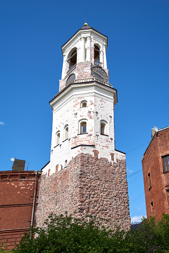 Old clock tower in old town, former bell tower of the old Cathedral Vyborg, Saint Petersburg. Russia. Clear blue sky