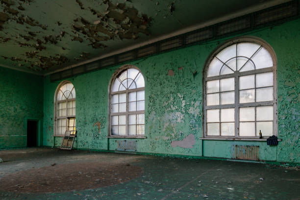 Large hall of abandoned building with peeled paint
