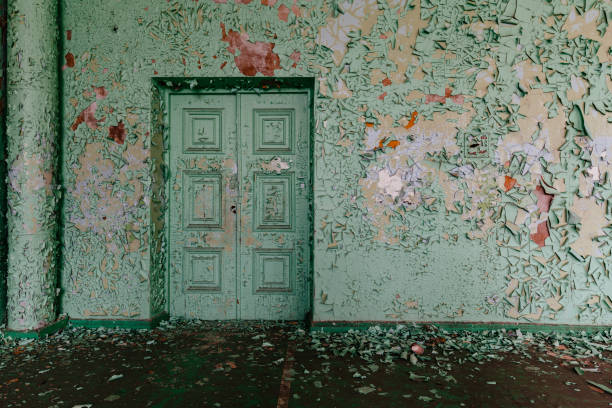 Old wall and door with peeling paint.