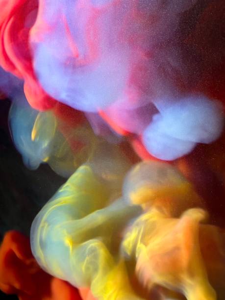 istock Colored fluids mixing in slow motion forming clouds and colorscapes 2069374825