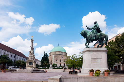 Downtown and city center in Pecs, street view with monuments in Hungary.