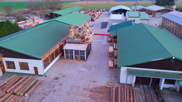 AERIAL Drone Shot of Buildings of Industrial Lumber Mill in Town