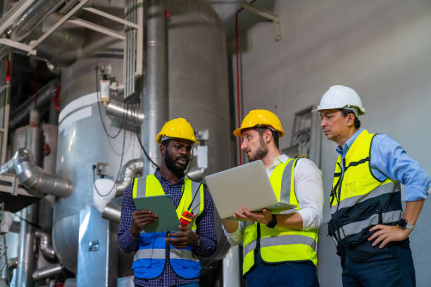 istock Group of Male engineer teamwork working together at factory site control room. 2069453790