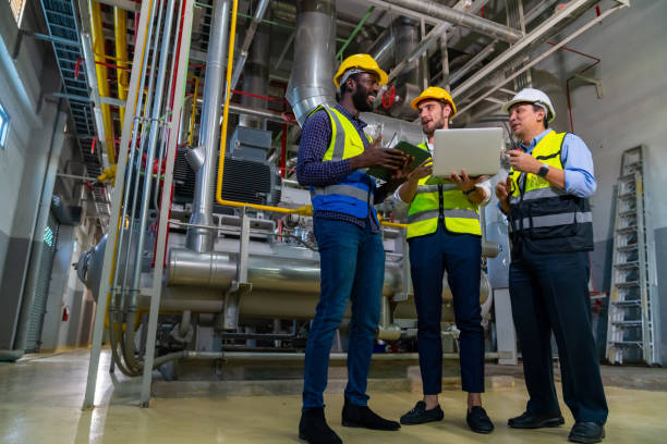 istock Group of Male engineer teamwork working together at factory site control room. 2069453795