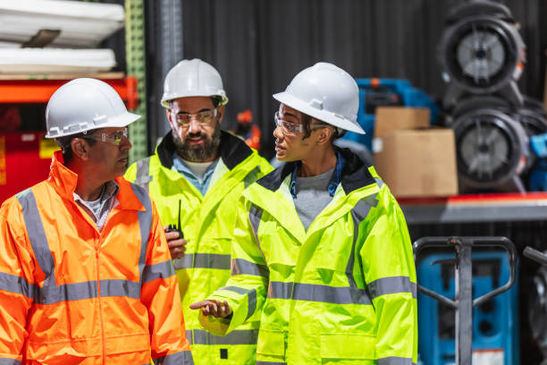 Multiracial workers in protective gear having discussion