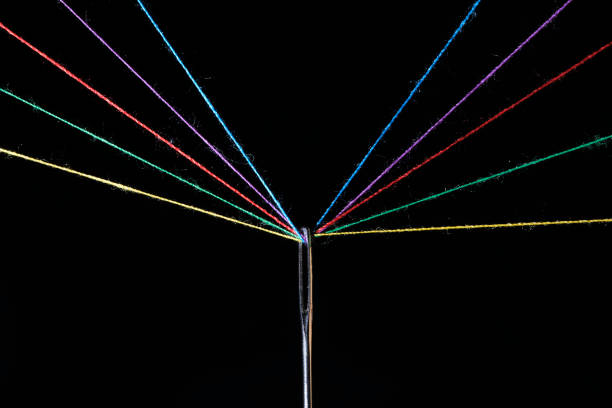 istock Eye sewing needle and multicolored threads passed through it black background. Concept hobbies and crafts. 2069613820