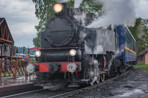 istock Retro steam train arrives to the platform. 2069619744
