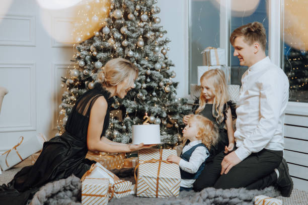 cheerful and happy family with christmas gifts celebrating birthday for two years. children are having fun. loving family with gifts in the room. - 2 3 years children only group of people enjoyment - fotografias e filmes do acervo