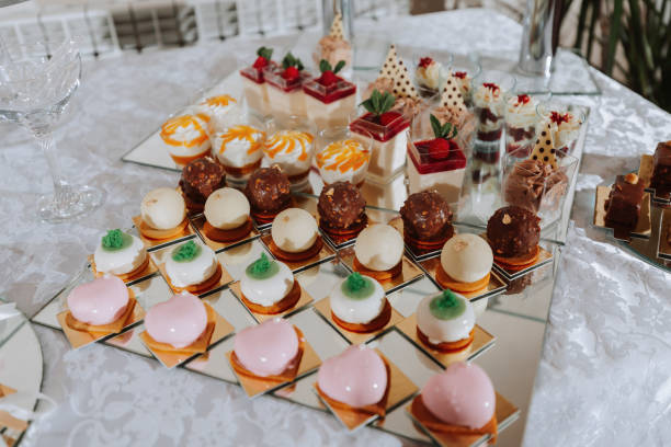 istock Festive dessert table with sweets. Wedding candy bar, various cakes, chocolates on stands. 2069629566