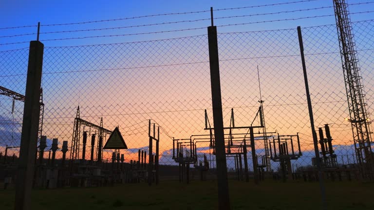 AERIAL Drone Shot of Silhouette Electric Power Station Under Sky at Sunset