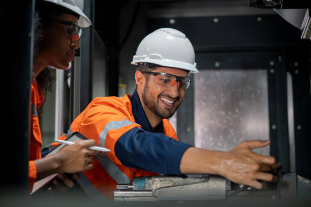 istock nspecting CNC Machine Cut Piece. Two expert engineers meticulously inspecting a freshly cut piece from a CNC machine. In this scene of collaborative expertise, work together to arrange and thoroughly examine the intricacies of the manufactured object. 2069693292
