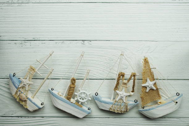 Nautical Sail boat model decoration with space copy on wooden background
