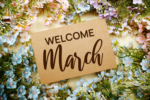 istock Welcome March text message with flower decoration on yellow background 2069745147