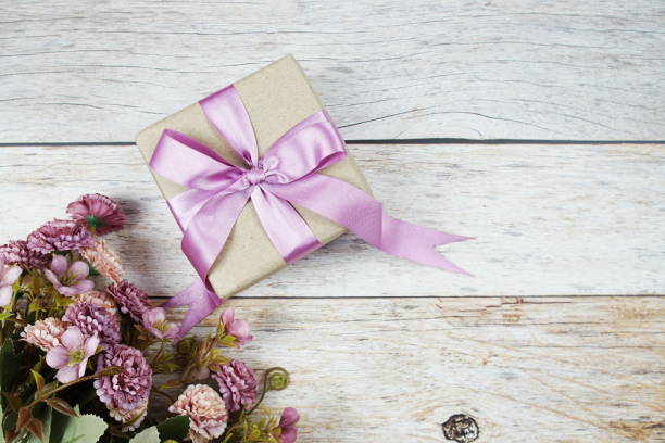 istock Gift box with pink ribbon with space copy on wooden background 2069757617
