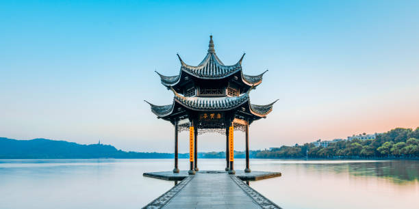 Jixian pavilion during sunrise in Hangzhou, Zhejiang province, China Jixian pavilion during sunrise in Hangzhou, Zhejiang province, China with all Chinese words on it only introduces itself which means "Jixian Pavilion "without advertisement. west lake stock pictures, royalty-free photos & images
