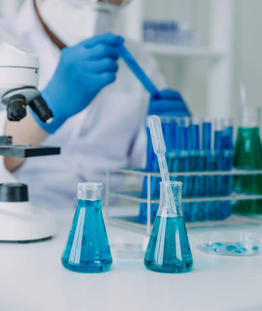 istock biochemical research scientist team working with microscope for coronavirus vaccine development in pharmaceutical research labolatory, selective focus 2069850105