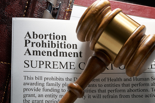 Abortion prohibition amendment document on binder with gavel and glasses