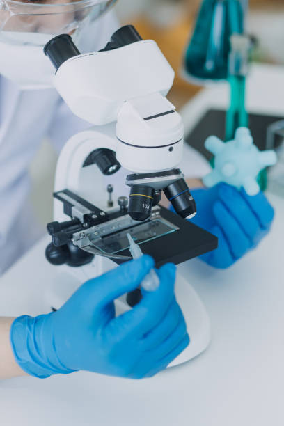 istock biochemical research scientist team working with microscope for coronavirus vaccine development in pharmaceutical research labolatory, selective focus 2069850138