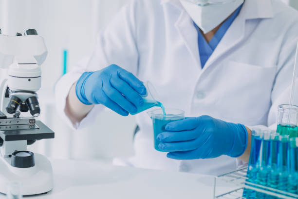 istock biochemical research scientist team working with microscope for coronavirus vaccine development in pharmaceutical research labolatory, selective focus 2069850140