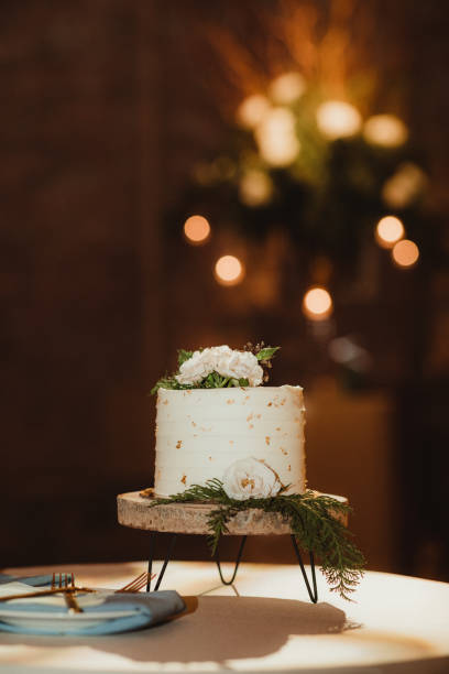 istock Small wedding cake on a cake stand with lights in the background 2069891207