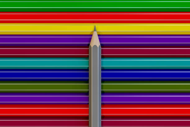 Many colored wooden pencils lie on the desk.