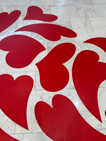 Stock photo showing close-up, elevated view of marble effect tiled flooring in public setting.