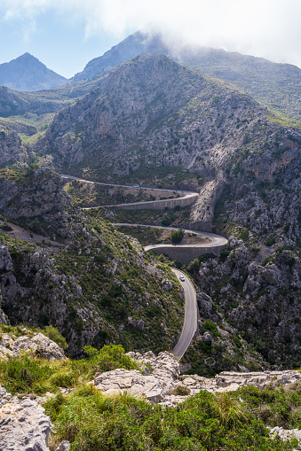 The famous Sa Calobra road in Mallorca, Spain, a favorite place for all cyclists. Lonely cyclists climb a winding road