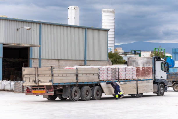 istock Trucker opening trailer doors to facilitate unloading pallets with a forklift. 2070095570
