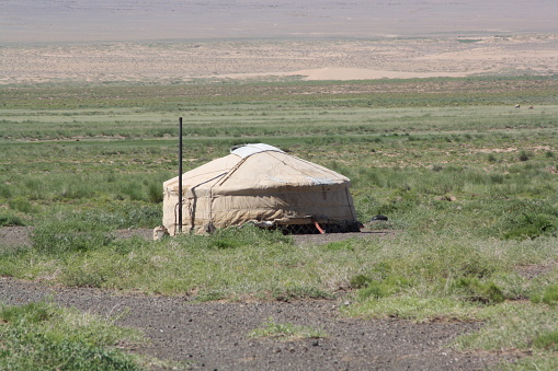 A nomadic family lives alone in the tranquility of a solitary Gobi desert, Umnugovi province, Mongolia. The surrounding desert is so vast and silent all year round. It is so hot in summer, too. There is some snow in winter. The nomadic life is fascinating.