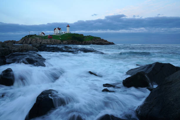 istock nubble lighthouse with rock beach in twilight 2070154183
