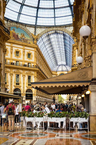 Crowd of customers and tourists inside the Galleria Vittorio Emanuele II in Milan, Italy