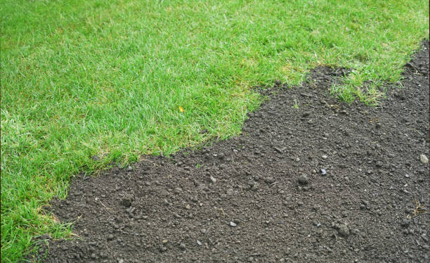 istock green lawn and dirt for new lawn 2070234087