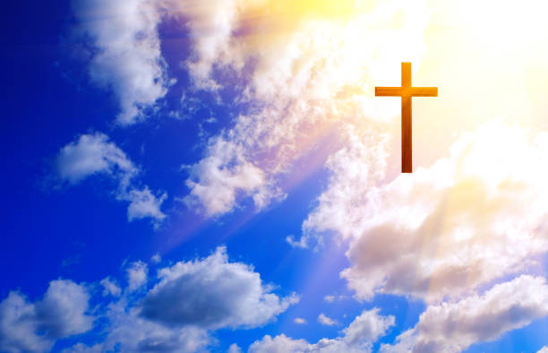 istock Cross on blue sky with clouds and sun. Christian religion concept. 2070234647