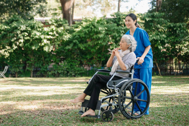 istock Asian physiotherapist helping elderly woman patient stretching arm during exercise correct with dumbbell in hand during training hand with patient Back problems in the garden. 2070235215