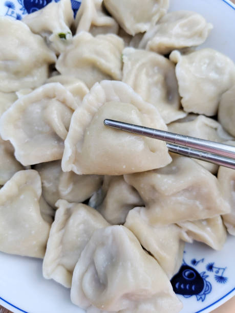 istock close up on chopstick and dumpling in the plate 2070240525