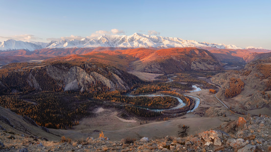 Wide morning autumn Kurai steppe landscape. Steppe with winding river on the background of mountains. Beautiful autumn view, mountain scenery, mountain panoramic view. Altai region.
