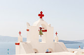 Cycladic bell tower with red elements on Santorini island, Oia, Greece